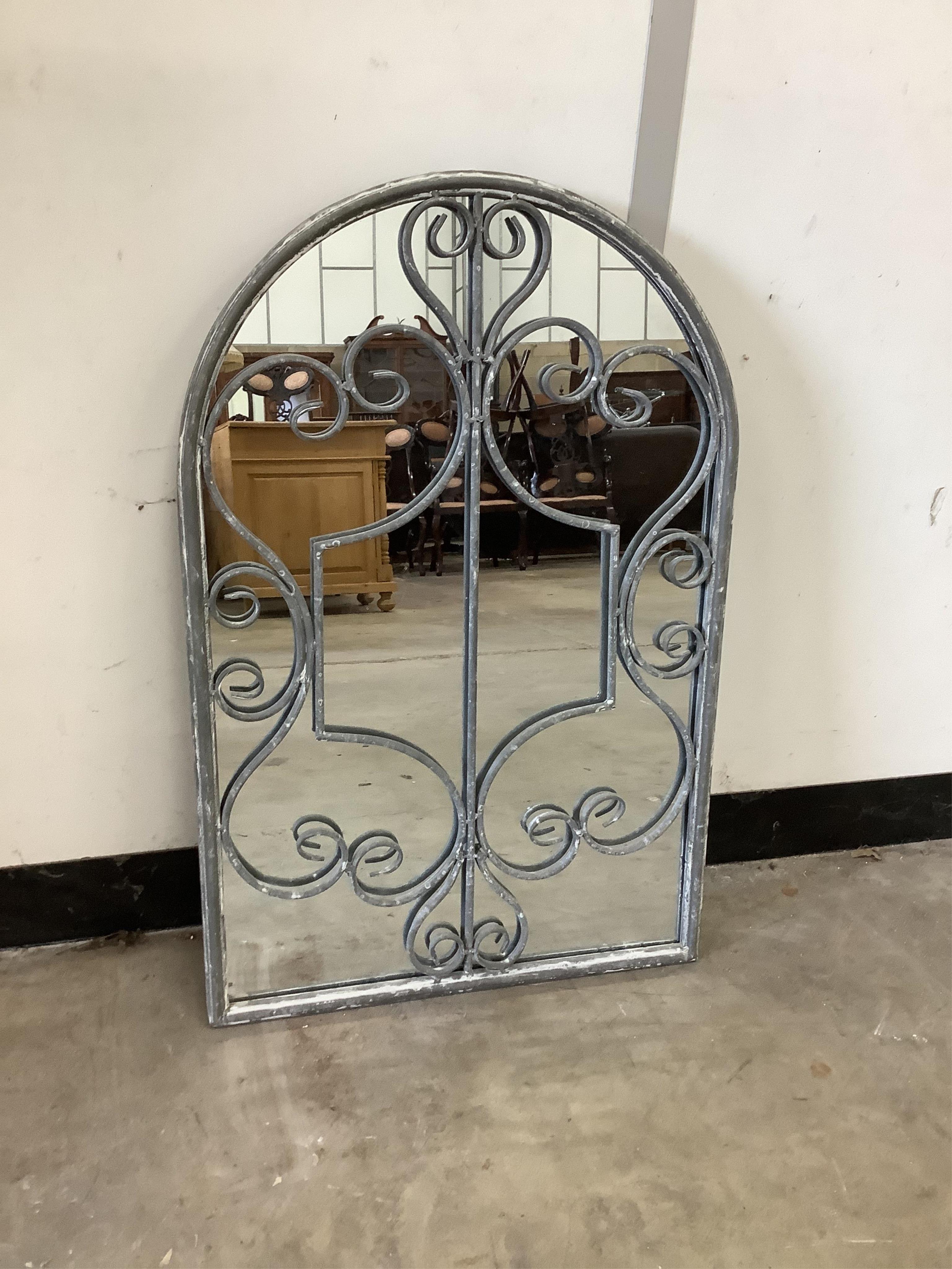 An oxidised wrought iron wall mirror, width 50cm, height 76cm. Condition - good